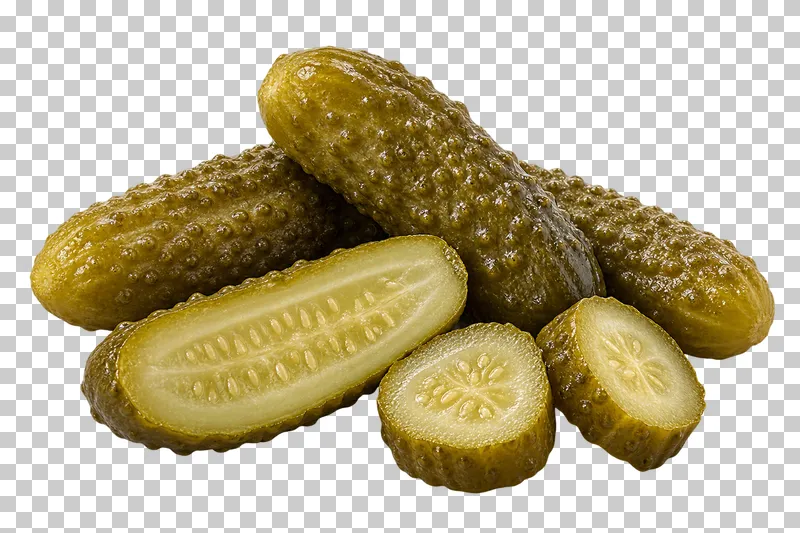 Whole cornichons beside a lengthwise half and round slices.
