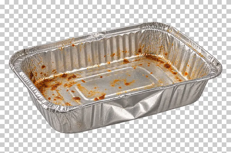 Dented foil takeaway tray with light food residue.
