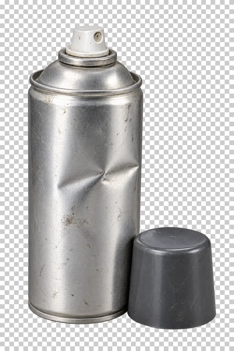 Discarded dented aerosol can with detached cap.