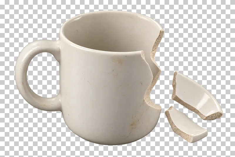 Broken ceramic mug with two detached pieces.