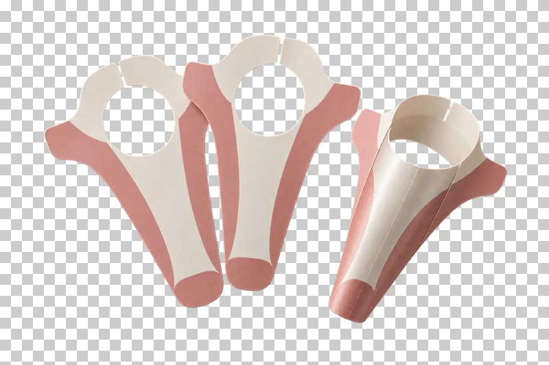 Three ivory and rose paper nail-extension forms, with one rolled into shape.