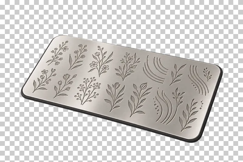 A rectangular steel nail-stamping plate engraved with botanical and curved-line designs.