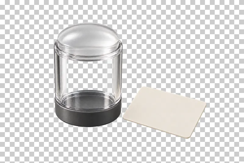 A clear silicone nail stamper with a graphite base beside an ivory scraper card.