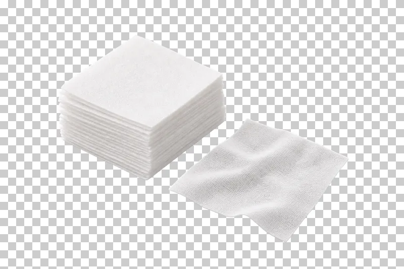 A neat stack of white lint-free nail wipes with one unfolded wipe beside it.