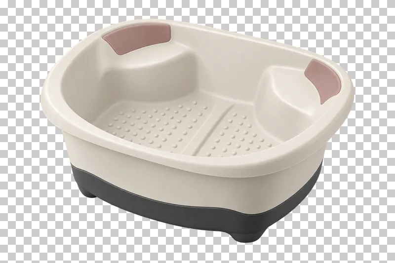 An empty ivory pedicure soaking basin with molded foot contours and a graphite base.