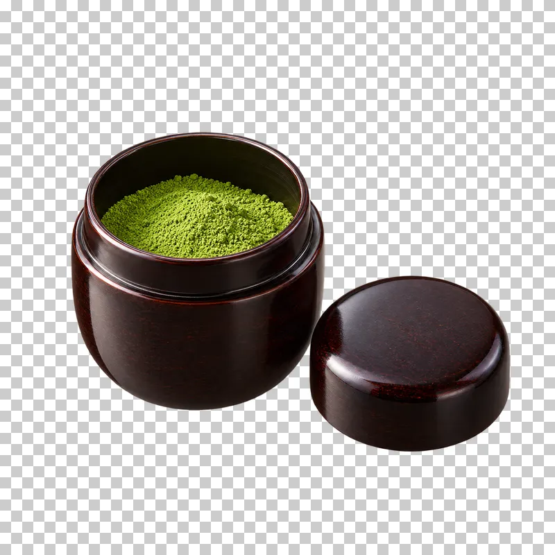 An open dark matcha caddy containing green powder, with its lid beside it.