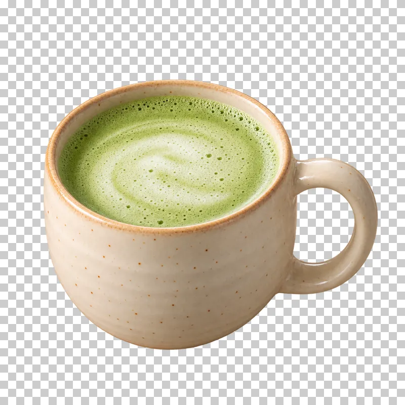 A green matcha latte with pale milk foam in an ivory ceramic mug.