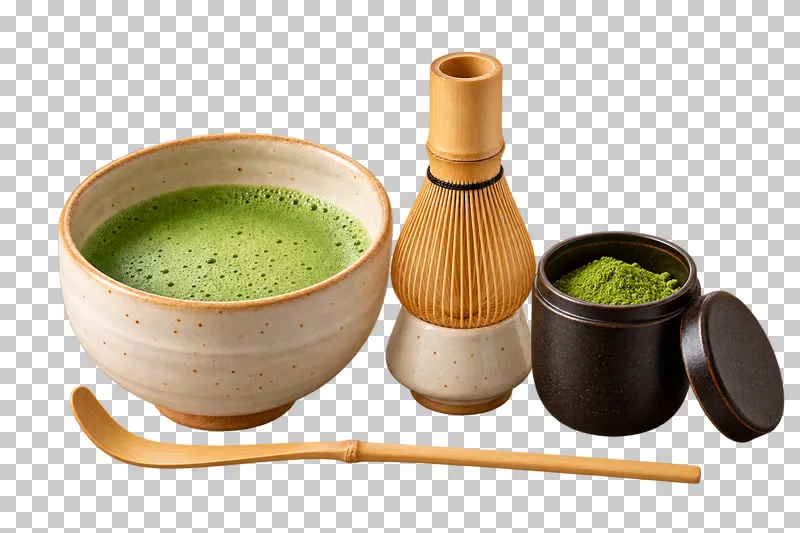 A matcha preparation kit with a filled chawan, whisk on a holder, bamboo scoop, and open caddy.