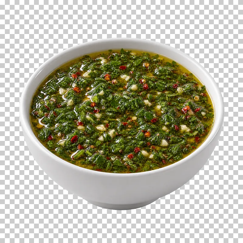 A plain white ceramic bowl filled with chimichurri.