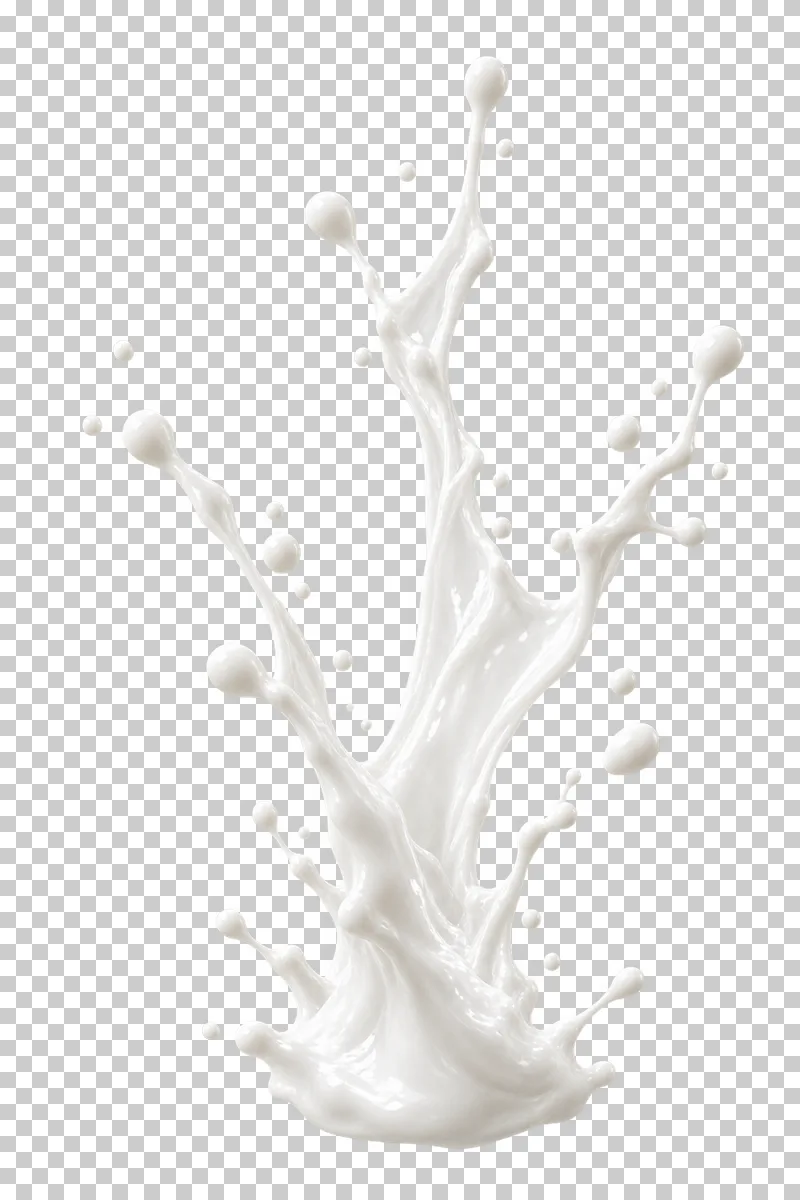 A narrow vertical milk splash with branching tips and detached drops.