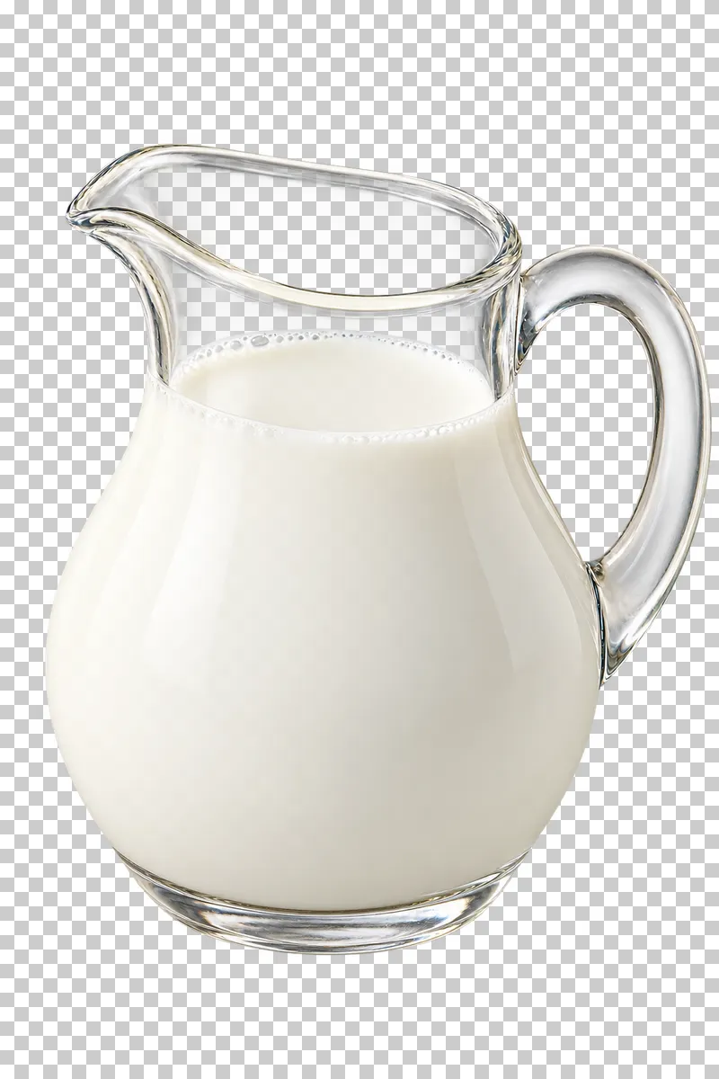 Opaque white milk in a clear glass jug with a handle and spout.