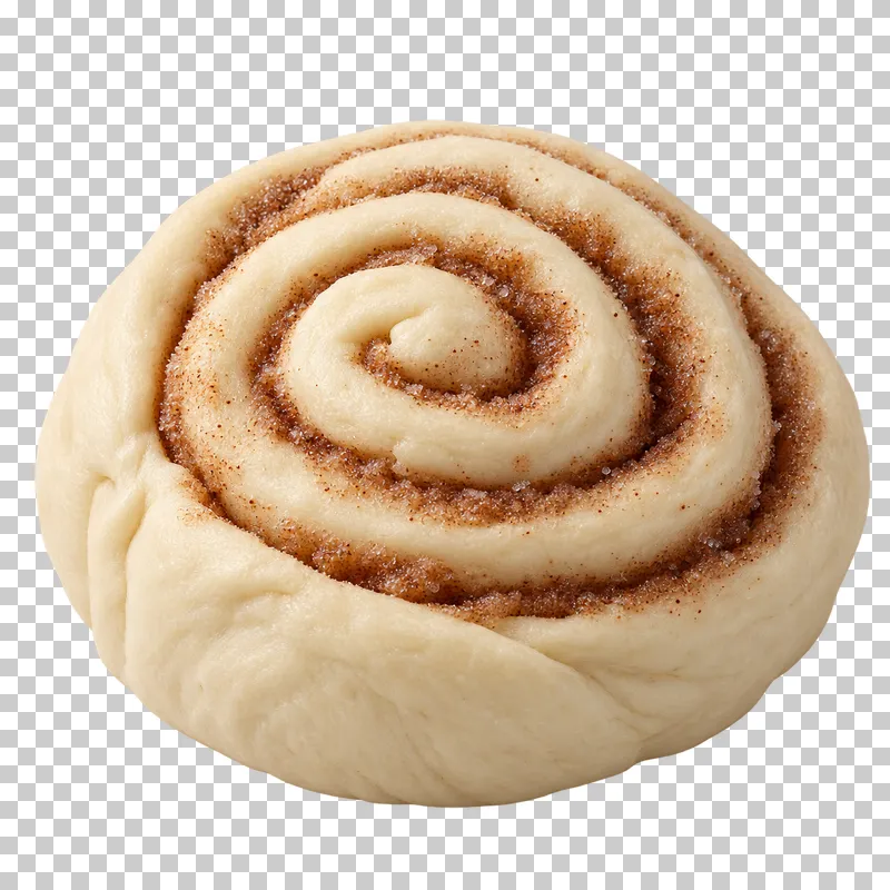 An unbaked cinnamon roll with filling between pale dough coils.