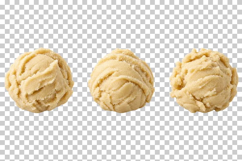 Three separate raw cookie dough scoops with natural scooping ridges.