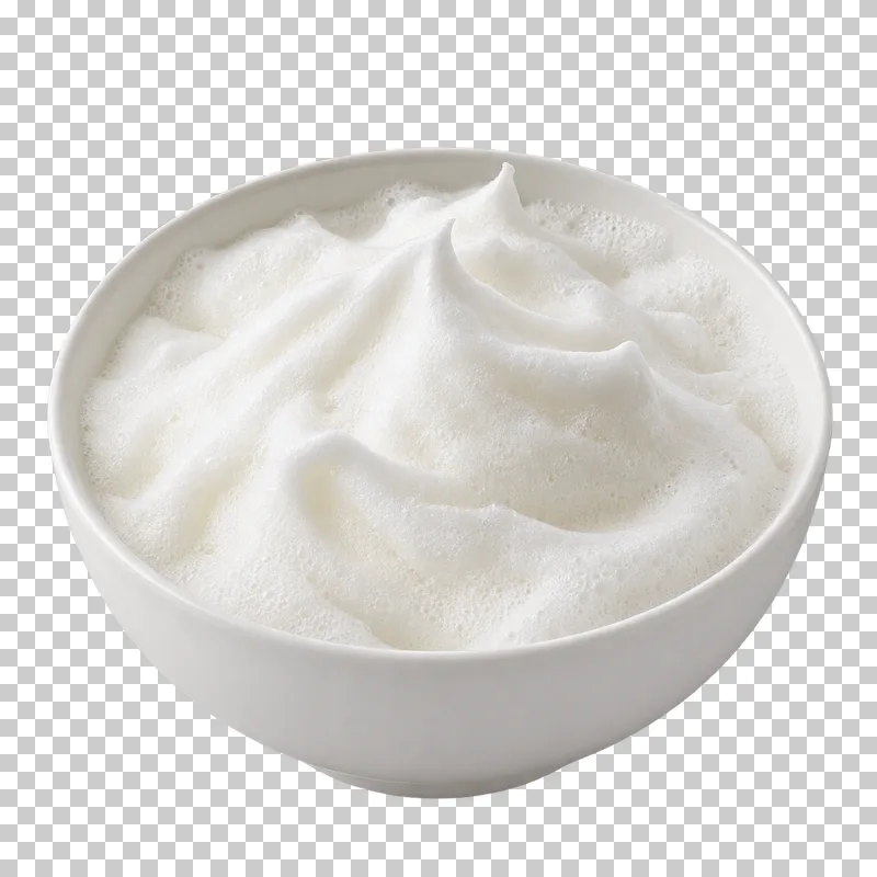 Aerated whipped egg whites with soft peaks in a white bowl.