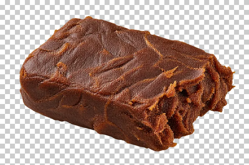 Pressed tamarind pulp block with natural dry texture, isolated on a transparent background.