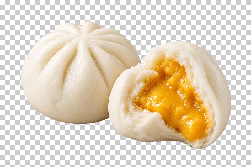 A whole pale custard bun beside a torn half with thick golden salted-egg filling.