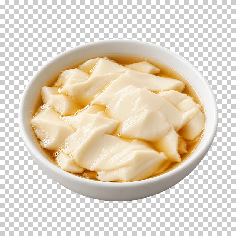 Soft irregular silken-tofu curds with clear amber syrup in a shallow white bowl.