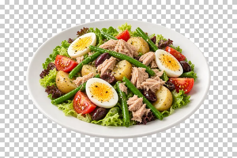 A white plate of tuna, egg, green beans, small potatoes, tomato and olives over salad leaves.