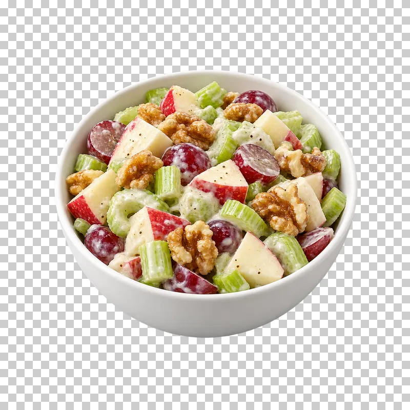 A white bowl of creamy Waldorf-style salad with apple, celery, grape halves and walnuts.