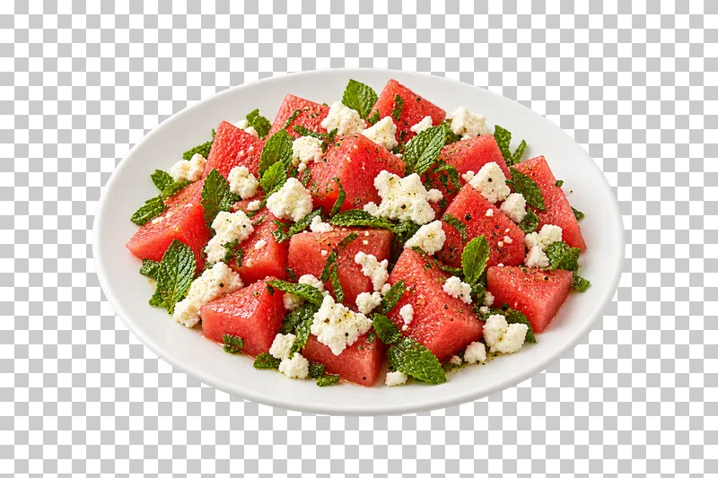 A white plate of angular watermelon pieces with feta and mint.