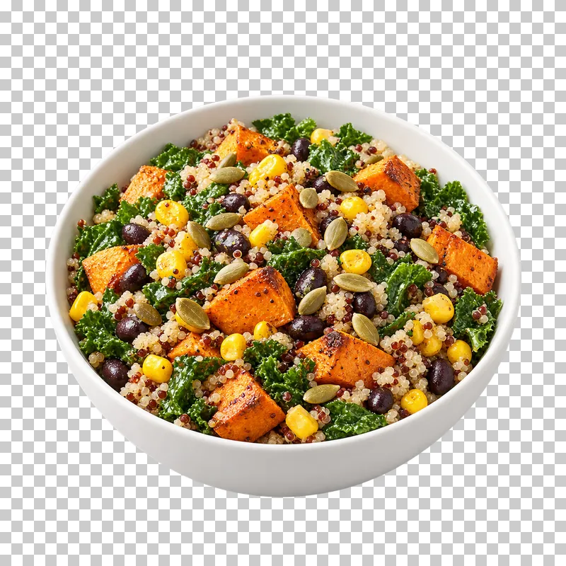 A white bowl of roasted sweet potato, black beans, quinoa, corn, greens and pumpkin seeds.