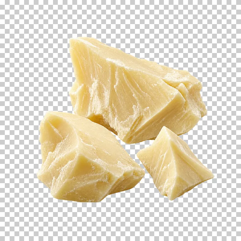 Three pale ivory-yellow cocoa butter shards with uneven broken surfaces.