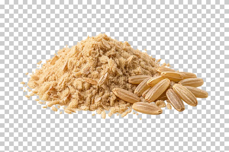 A tan rice bran mound beside a small group of brown rice grains.