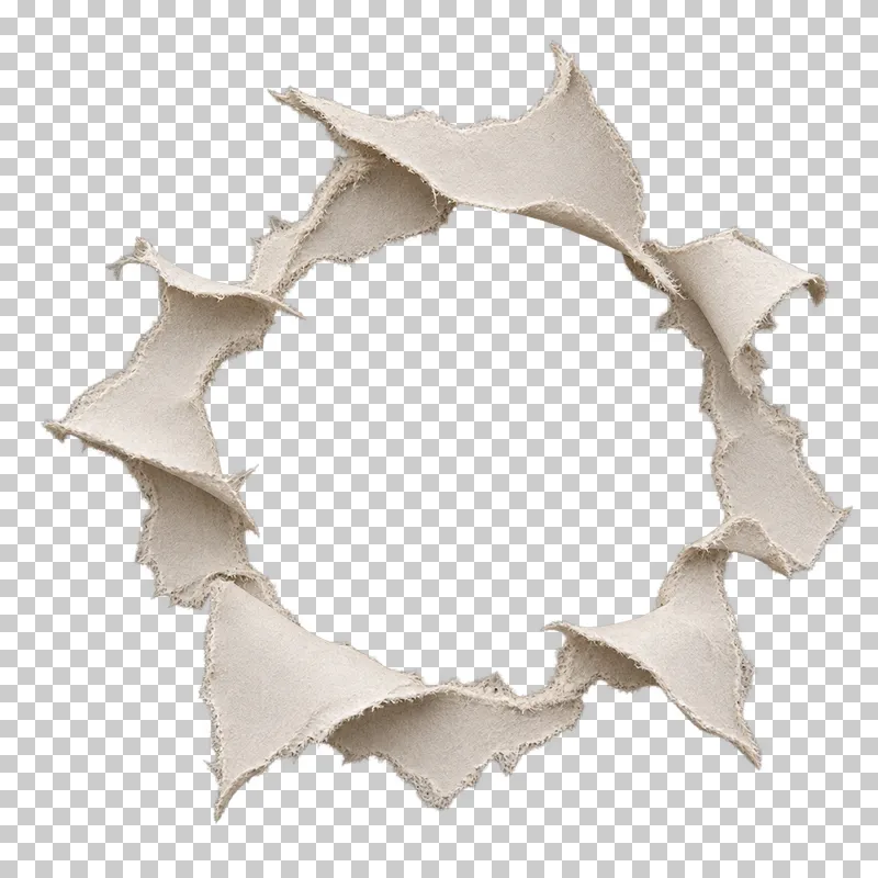 An irregular circular paper opening surrounded by pointed outward curls and torn fiber edges.