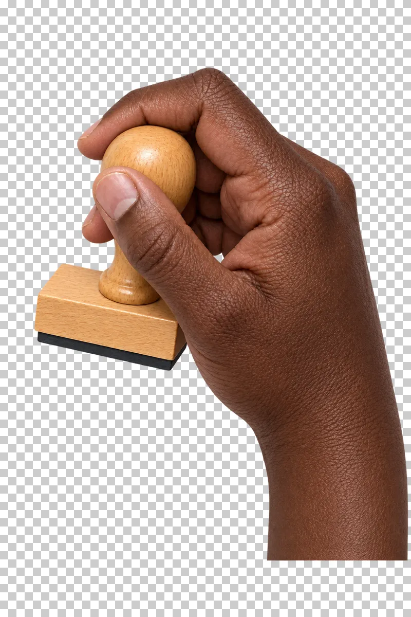 A deep-brown hand grips a wooden rubber stamp with a rectangular black base.