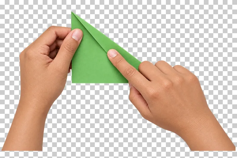 Two light-medium hands steady and press the diagonal fold of a green paper sheet.