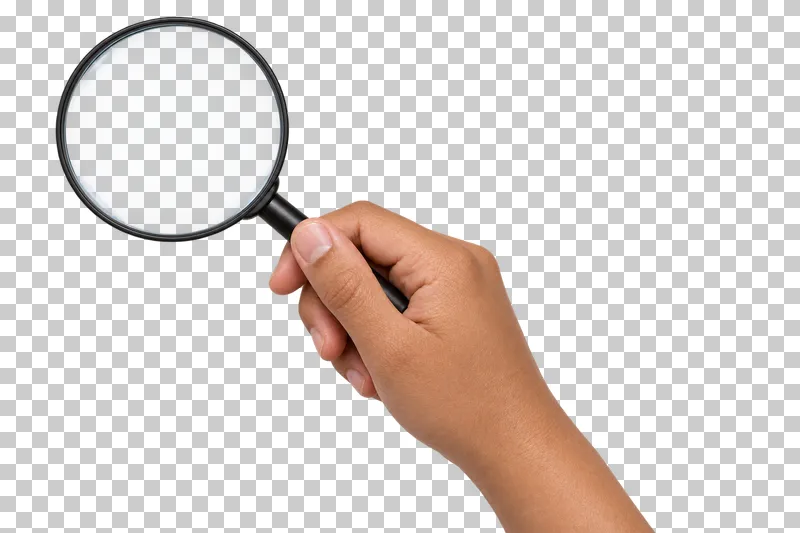 A light-medium hand grips a black magnifying glass with a translucent clear lens.