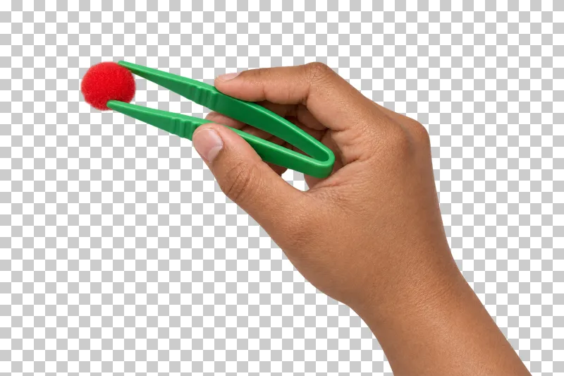 A medium-brown hand uses green tweezers to hold one red pompom.