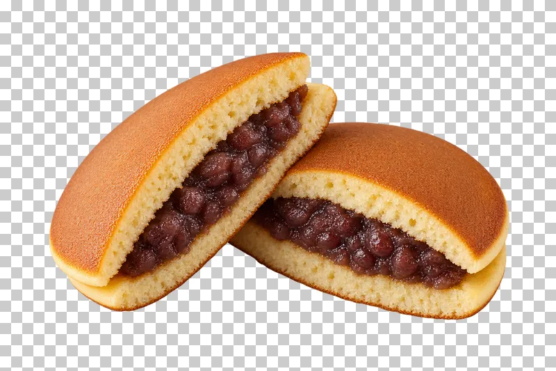 Two cut dorayaki halves showing red-bean filling between golden pancakes