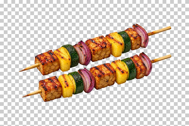 Two complete bamboo skewers threaded with tempeh, pineapple, zucchini and red onion.