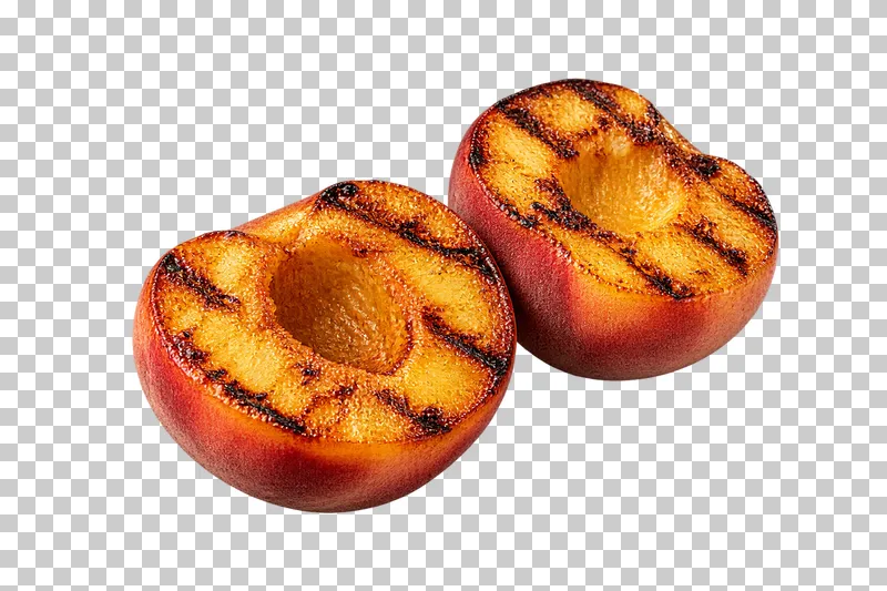 Two grilled pitted peach halves with red-blushed skins and empty stone cavities.