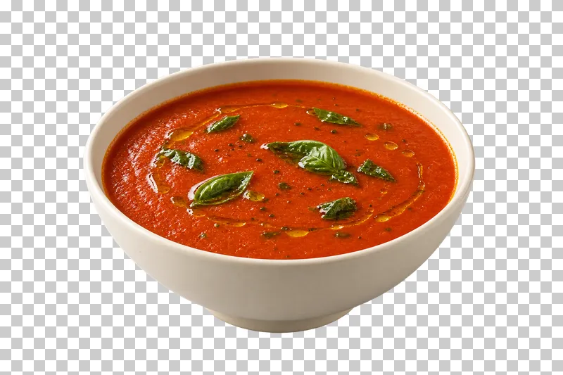 An ivory bowl of tomato basil soup with basil leaves and olive oil.