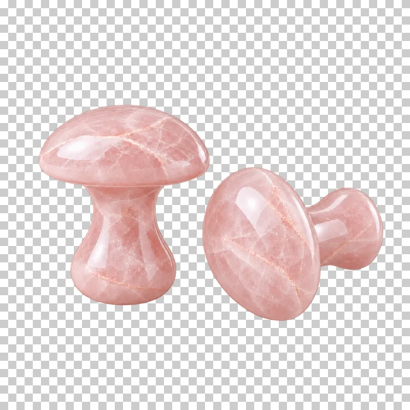 Two pale stone mushroom-shaped facial massagers with short handles.