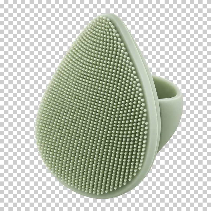 A sage silicone facial cleansing pad with fine textured nubs.