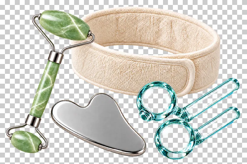 A jade roller, steel gua sha, two clear cooling globes and terry headband arranged together.