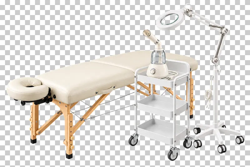 An ivory treatment table, a trolley holding a facial steamer, and a floor-standing magnifying lamp.