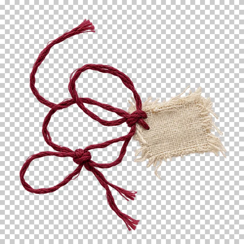 A loose burgundy thread tangle with two knots attached to a small frayed linen anchor.