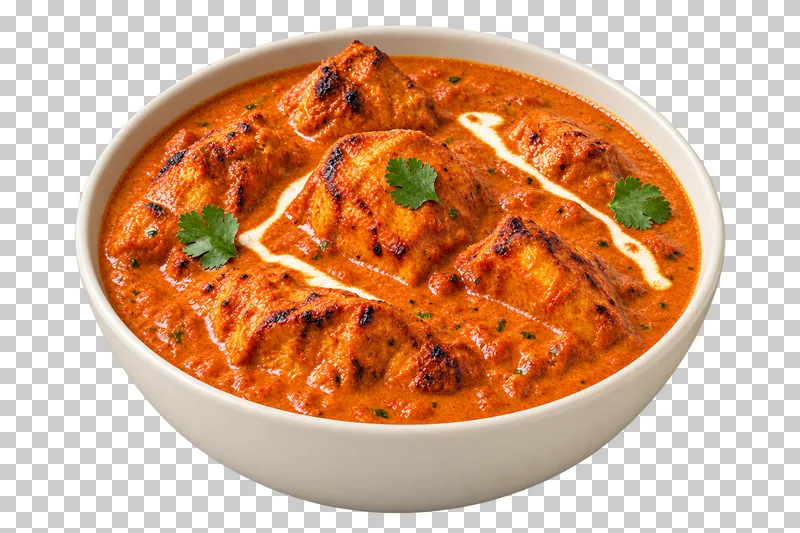 Boneless tandoor-style chicken pieces in a thick orange tomato-butter sauce, with restrained cream streaks and a few attached coriander leaves, in a shallow ivory bowl.