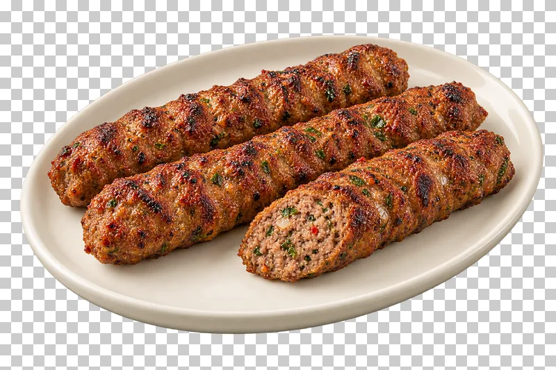 Three elongated ridged minced-lamb kebabs, one cut to show the minced interior, on a plain oval ivory plate