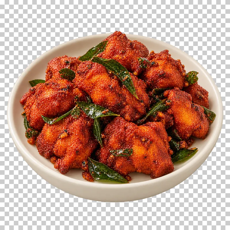 A compact portion of irregular crisp red-spiced boneless chicken pieces with attached fried curry leaves, on a small round ivory plate.