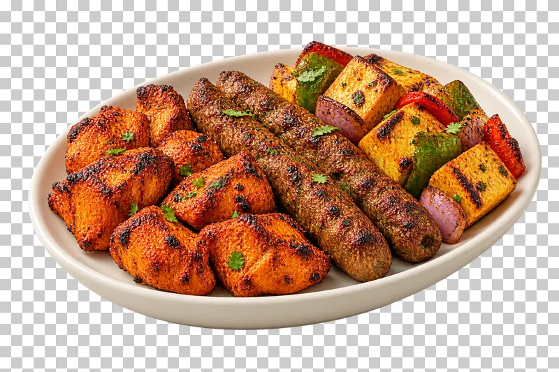 One oval ivory sharing platter with separate compact groups of chicken tikka, lamb seekh kebabs and paneer tikka pieces with peppers