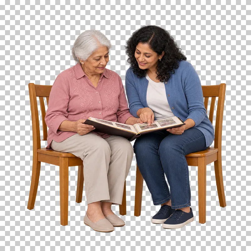 An older woman and an adult relative look through an open photo album together.