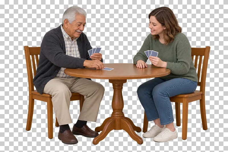 An older man plays a card at a table while a female companion holds her cards.