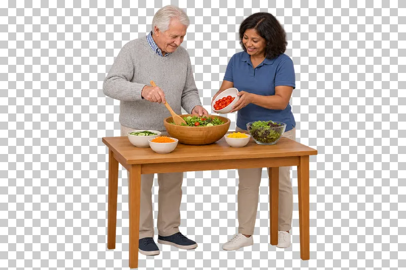 An older man stirs a salad while a companion supports a bowl of prepared ingredients.