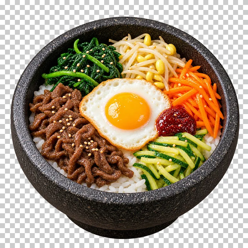 Dolsot bibimbap with rice, beef, spinach, sprouts, carrot, zucchini, one fried egg and gochujang in a black stone bowl.