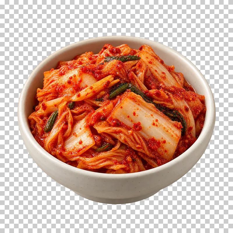 Red-seasoned baechu kimchi with folded napa leaves and pale cabbage ribs in a small ivory bowl.
